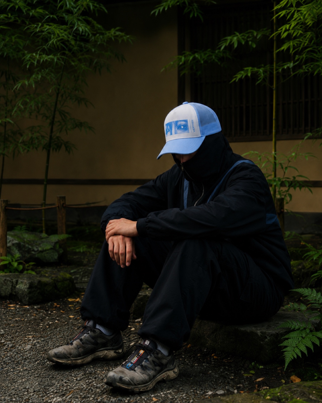 Model seated in the garden in the track jacket